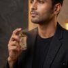 Junoon Eau de Parfum Application – Mandakani Perfumers Male model applying Junoon Eau de Parfum by Mandakani Perfumers on body and clothing